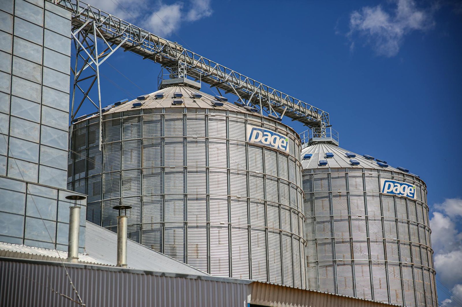 Industrial grain silos in Paragominas, Brazil under a clear blue sky.