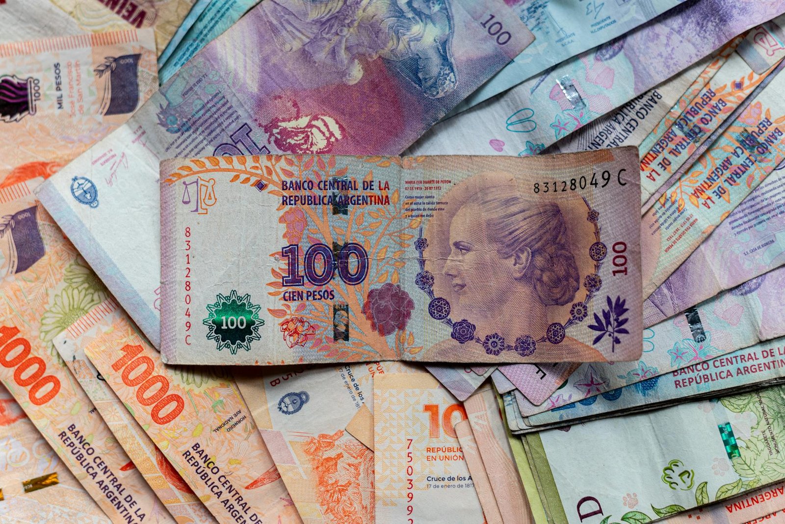 A collection of colorful Argentinian peso bills, featuring diverse denominations and designs.