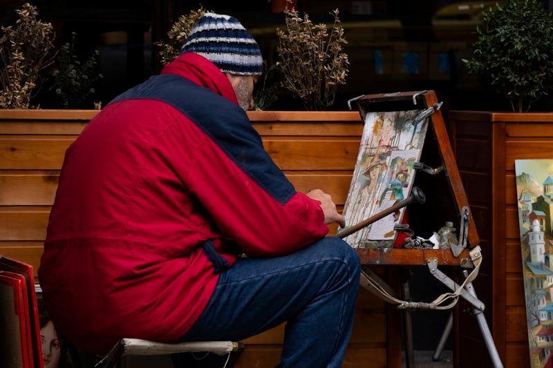 painter paints at the side of the street