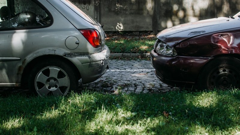 a couple of cars that are sitting in the grass