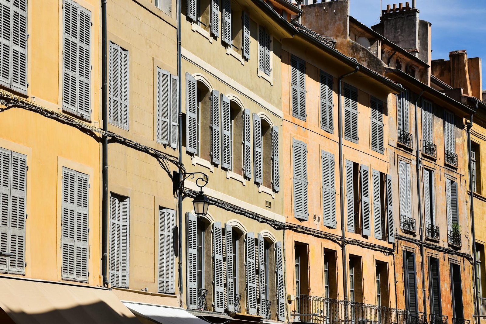 Elegant traditional buildings with shuttered windows in Aix-en-Provence, France.
