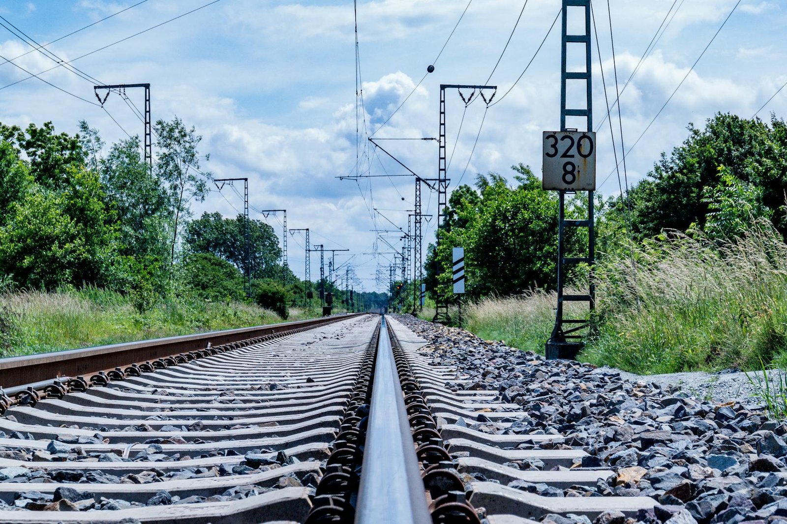 Close-up of railway tracks with utility poles in Leer, Germany, scenic travel route.