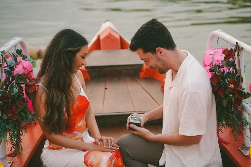 Man proposes to woman in a decorated boat.