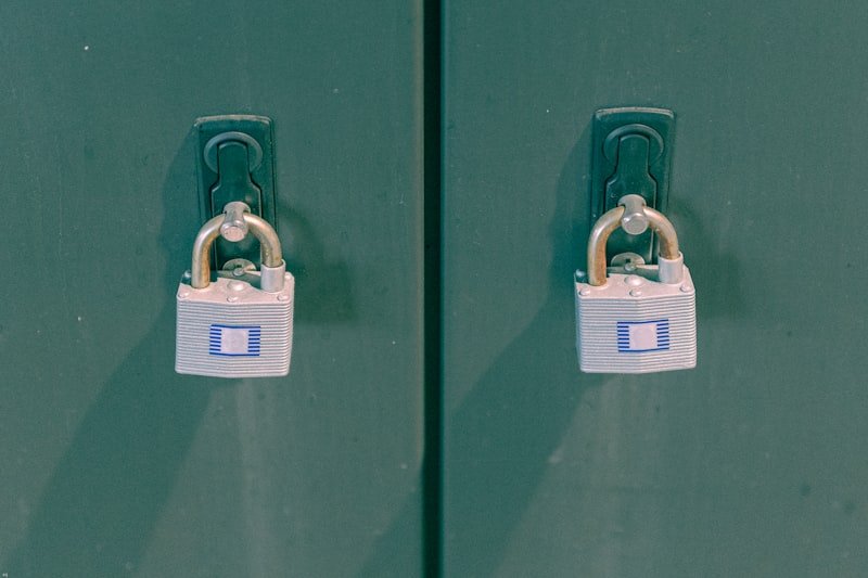 two green lockers with padlocks on them