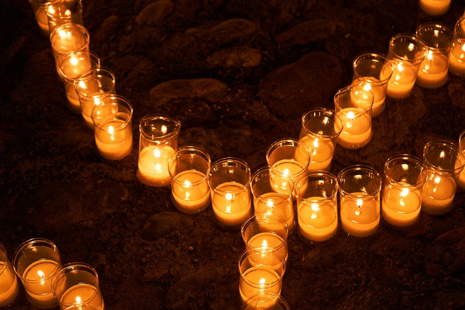 Candles arranged outdoors at night in Pedraza, creating a warm, glowing ambiance.