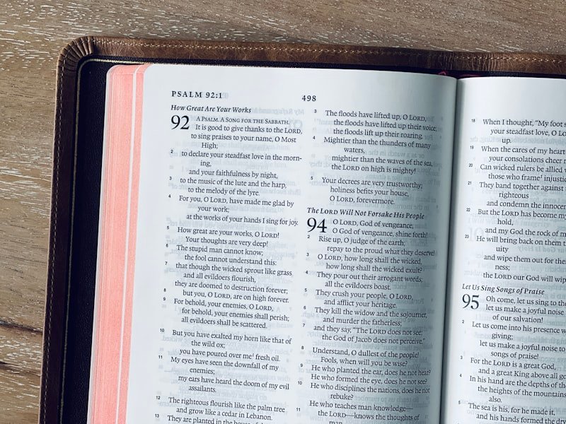 An open bible displays psalm 92 on its pages.