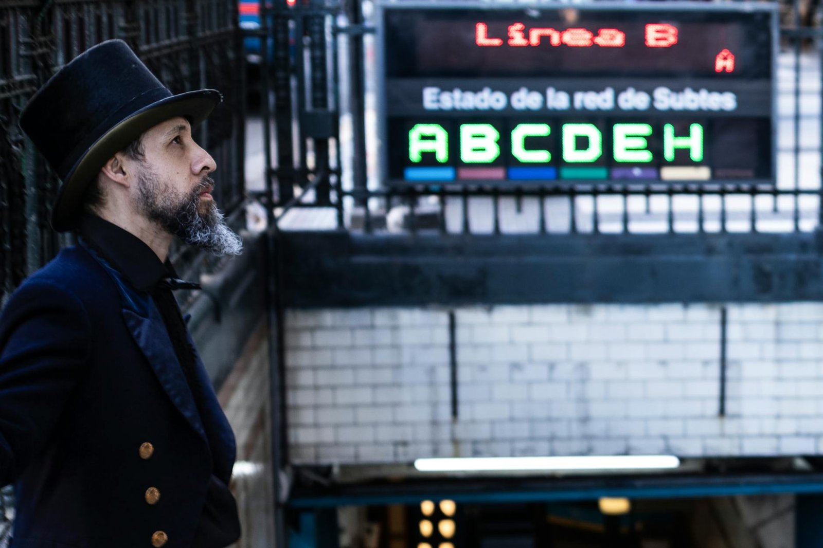 Stylish gentleman in a top hat at Buenos Aires subway entrance, Línea B.
