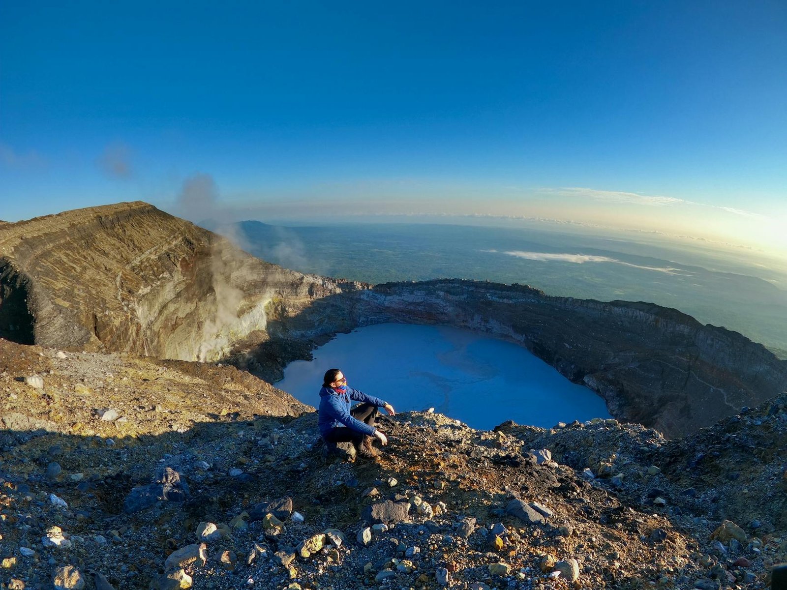 A person enjoys the breathtaking view from the top of Rincón de la Vieja Volcano, Costa Rica.