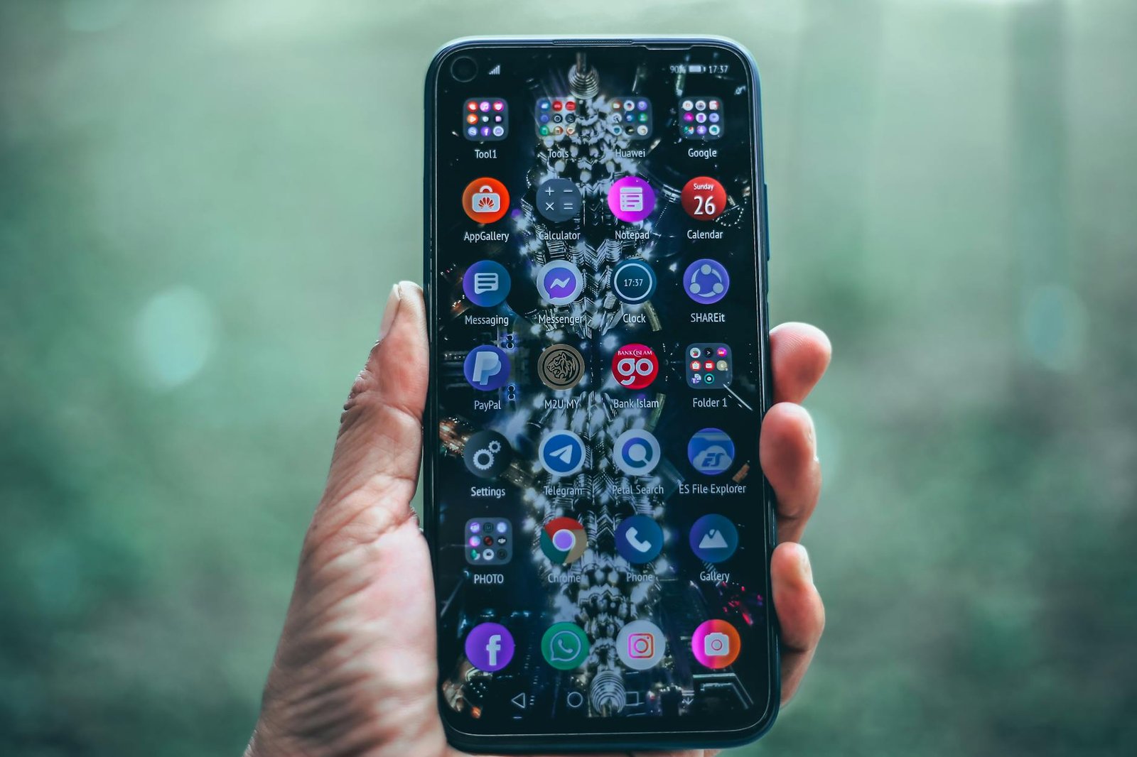 Smartphone with various apps in hand, focus on technology and connectivity.